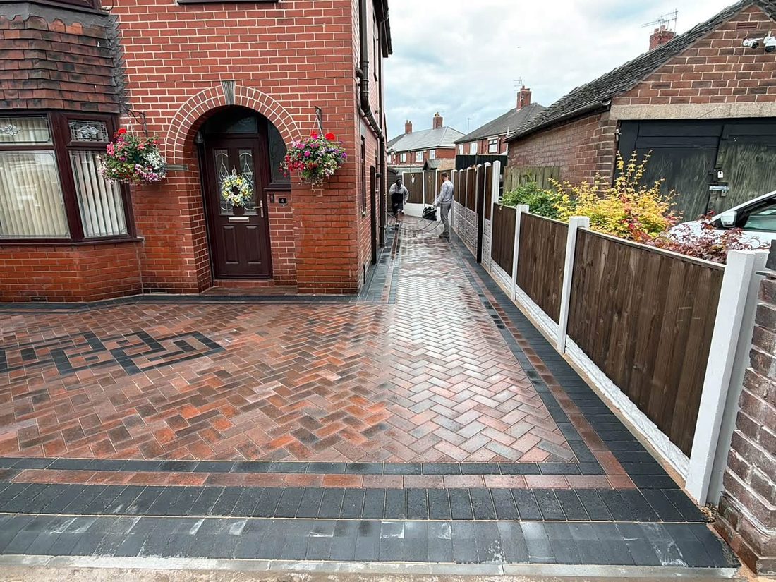 Herringbone block paved drive with a charcoal contrast border