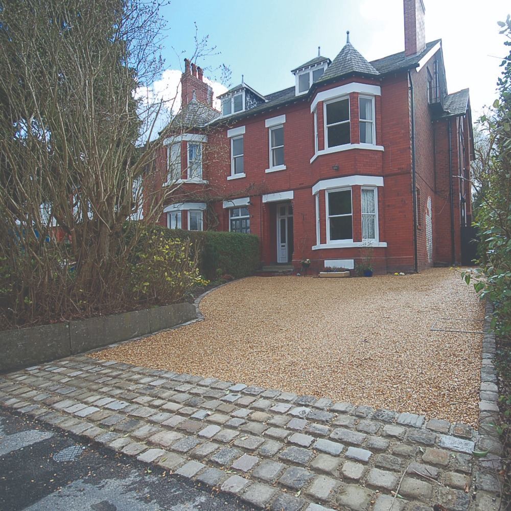 Gravel driveway with cobbled edging