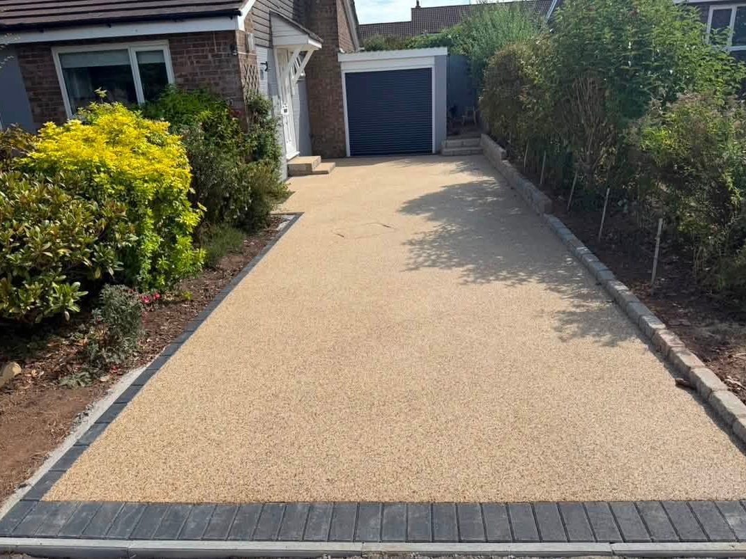 Buff resin bound driveway with charcoal block edging